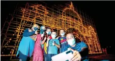  ?? Photo — Bernama ?? Visitors take a photo in front of giant ‘panjut’ at Kampung Ribu.