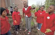  ?? TO THE COMMERCIAL APPEAL BRANDON DILL / SPECIAL ?? Jan. 27, 2012: Klondike Elementary School fourth-grade teacher Allyson Cathey shows off a worm for students Courtney Pinkins, from left, Nia Reaves, Samaria Davis and Isiah Harris as they work to transform the school's garden into a successful model of community gardening.