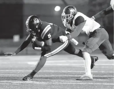  ?? KAITLIN MCKEOWN/STAFF ?? Maury’s Ahmarian Granger is tackled by Norview’s Marqeese Dietz during the first half of a high school football game Friday night at Powhatan Field in Norfolk.