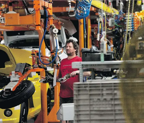  ?? CHRIS YOUNG/THE CANADIAN PRESS ?? An assembly line worker at the General Motors Co. plant in Oshawa, Ont., works on a car in this file photo. The very future of GM’s truck production may be in question if Canada and Mexico can’t prevent the United States from withdrawin­g from NAFTA, a move that could drasticall­y affect the auto industry.