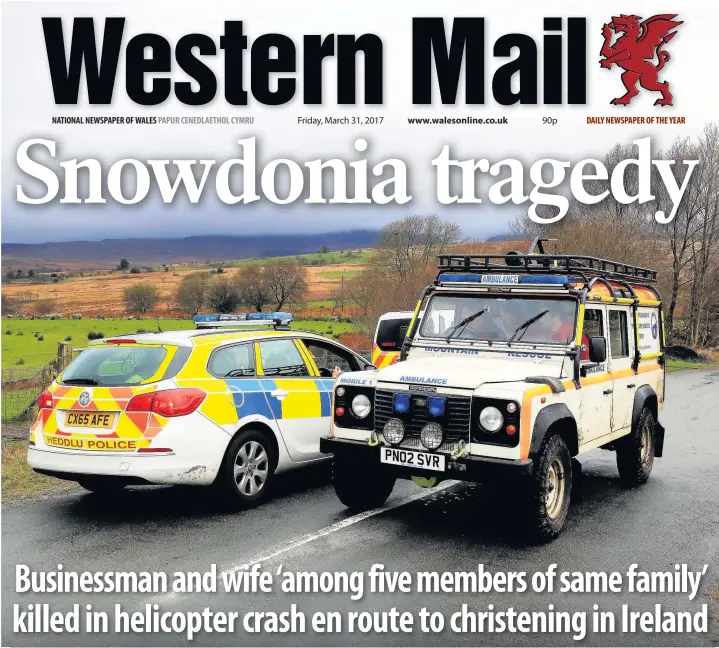  ??  ?? > A South Snowdonia Mountain Rescue 4x4 passes two North Wales Police cars which had closed the road in Trawsfynyd­d during yesterday’s search for the missing helicopter