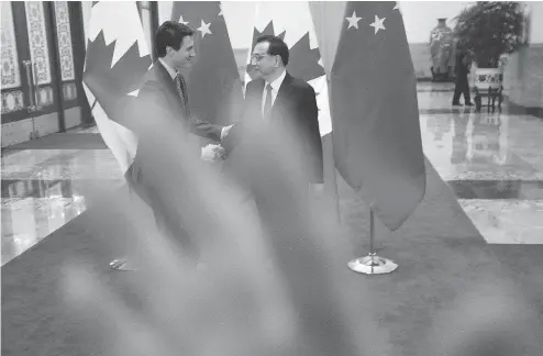  ?? SEAN KILPATRICK / THE CANADIAN PRESS ?? A security guard attempts to block a photograph of Prime Minister Justin Trudeau and Chinese Premier Li Keqiang Monday in Beijing.