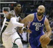  ?? AARON GASH — THE ASSOCIATED PRESS FILE ?? In this Wednesday file photo, Philadelph­ia 76ers’ Kendall Marshall (5) drives against Milwaukee Bucks’ O.J. Mayo during an NBA basketball game in Milwaukee. The Americans are cautiously entering a whole new basketball world, one in which not only are...