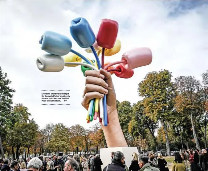  ?? — AFP ?? Spectators attend the unveiling of the ‘Bouquet of Tulips’ sculpture by US artist Jeff Koons near The Petit Palais Museum in Paris.