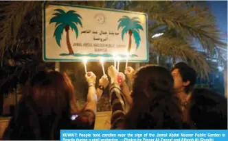  ??  ?? KUWAIT: People hold candles near the sign of the Jamal Abdul Nasser Public Garden in Rawda during a vigil yesterday. —Photos by Yasser Al-Zayyat and Athoob Al-Shuaibi