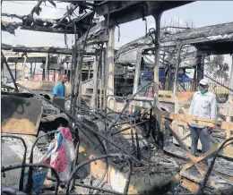  ?? SUNDAY ALAMBA/AP PHOTOS ?? The charred remains of buses Saturday in Lagos, Nigeria, after days of peaceful protests over police abuses turned deadly. A 24-hour curfew was loosened Saturday in the city.