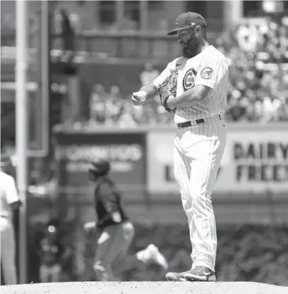  ?? JOHN J. KIM/CHICAGO TRIBUNE ?? Cubs starter Jake Arrieta holds a ball after giving up a two-run homer to Miami’s Adam Duvall in the first inning.