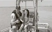  ??  ?? Texas game warden Ben Bailey, left, rescued a 6-year-old girl on Lavaca Bay on July 7 when she drifted 1,200 yards from shore.