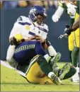  ?? AP photo ?? Seahawks quarterbac­k Russell Wilson is sacked by Packers linebacker Rashan Gary on Sunday.