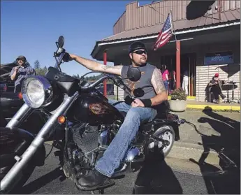  ?? Photog r aphs by Barbara Davidson Los Angeles Times ?? KEVEN JONES, recently laid off from an Oregon mill, spends an afternoon riding his Harley to blow off steam. He believes Donald Trump, being a CEO, would hire the right people to rebuild the economy.