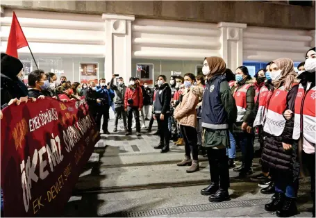  ?? AFP ?? Police block Istiklal Street, the main shopping area of Istanbul, as they stand in front of protesters denouncing the violence against women.