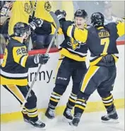  ?? Gene J. Puskar Associated Press ?? ROOKIE JAKE GUENTZEL, center, celebrates after breaking a 3-3 tie at 16:43 of the third period.