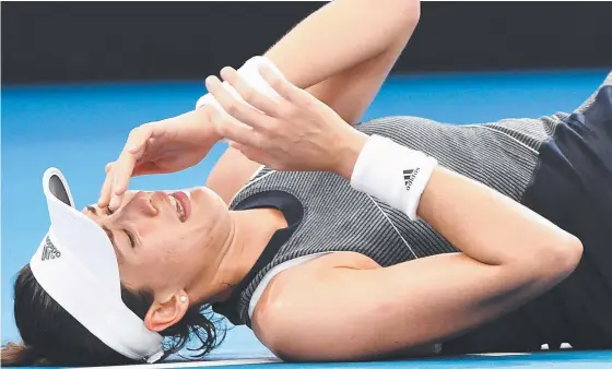  ?? Picture: AAP IMAGE ?? RETIRED HURT: Spaniard Garbine Muguruza succumbs to a leg cramp during her second- round match at the Brisbane Internatio­nal yesterday.