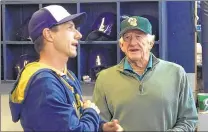  ??  ?? Craig Counsell and Bob Uecker visit in the Brewers dugout at Miller Park on Wednesday. The two have a long history together.