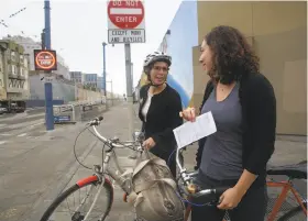  ?? Liz Hafalia / The Chronicle 2015 ?? Jean Fraser (left) talks with Katrina Sostek about a ticket received for not stopping at a stop sign on Duboce and Church streets in San Francisco in 2015.