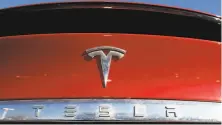  ?? David Zalubowski / Associated Press ?? Shares of Tesla rose after the company’s disclosure­s.