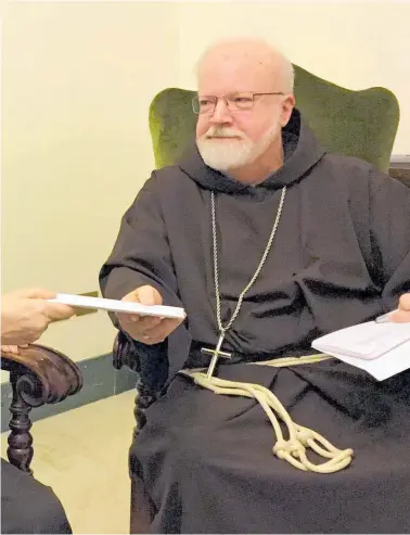  ?? Pictures / AP ?? Marie Collins, a member of the Pope's sex-abuse commission, is pictured in 2015 handing a letter to Cardinal Sean O'Malley detailing the abuse of Juan Carlos Cruz and claims of a coverup by Chilean church authoritie­s.