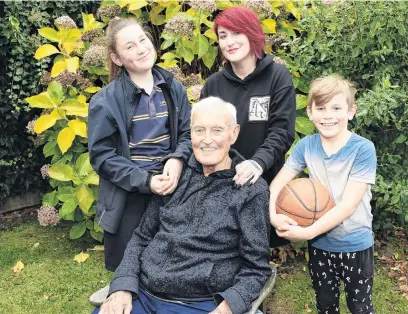  ?? PHOTO: GREGOR RICHARDSON ?? Family man . . . Lance Pearson with grandchild­ren Tilly (12, left) and Maxwell (8), and daughter Marnie (behind), after being made a life member of Basketball Otago this year.