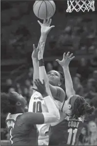  ?? NWA Democrat-Gazette/J.T. Wampler ?? RISING UP: Arkansas’ Kiara Williams (10) takes a shot over Alabama’s Quanetria Bolton (1) and Hannah Cook (11) Sunday.