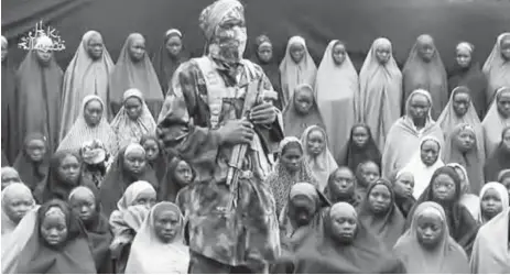  ??  ?? A screen grab from Boko Haram’s latest video show some of the kidnapped girls