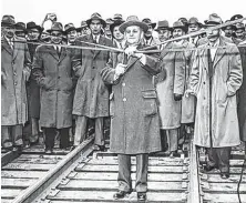  ?? STRAIT AREA MUSEUM PHOTO ?? C.N.R. officials gathered to watch president Donald Gordon cut the ribbon to declare the Canso Causeway was open to train and vehicular traffic, in May 1955.