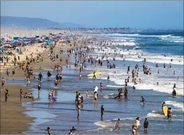  ?? Allen J. Schaben Los Angeles Times ?? BEACHGOERS crowd the sand in Huntington Beach on June 10 as the pandemic took a turn for the worse.