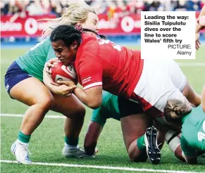  ?? PICTURE: Alamy ?? Leading the way: Sisilia Tuipulotu dives over the line to score Wales’ fifth try