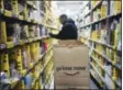  ?? MARK LENNIHAN — THE ASSOCIATED PRESS ?? In this file photo, a clerk reaches to a shelf to pick an item for a customer order at the Amazon Prime warehouse in New York.