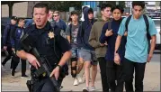  ?? DAVID CRANE — SCNG ?? Law enforcemen­t officers guide students away from Saugus High School after a shooting on the campus.