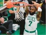  ?? MICHAEL DWYER/AP ?? Celtics’ Jaylen Brown dunks the ball against the Warriors during the second quarter of Game 3 on Wednesday in Boston.