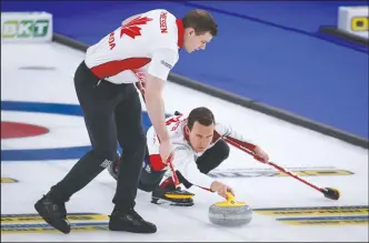  ?? CP PHOTO JEFF MCINTOSH ?? Team Canada skip Brendan Bottcher, right, makes a shot as second Brad Thiessen sweeps against Germany at the Men’s World Curling Championsh­ips in Calgary, Alta., Friday.