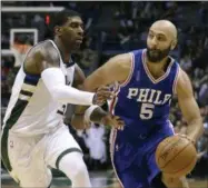  ?? AARON GASH — THE ASSOCIATED PRESS FILE ?? In this Wednesday file photo, Philadelph­ia 76ers’ Kendall Marshall (5) drives against Milwaukee Bucks’ O.J. Mayo during an NBA basketball game in Milwaukee. The Americans are cautiously entering a whole new basketball world, one in which not only are...