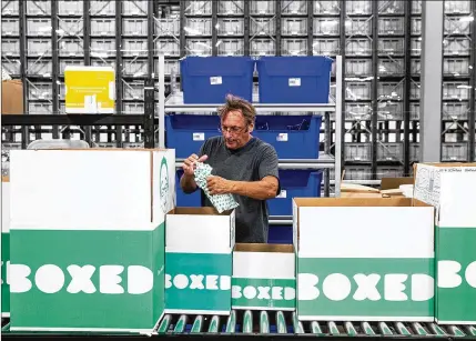  ?? JEENAH MOON / THE NEW YORK TIMES ?? An employee packs a box at the Boxed warehouse in Union, N.J. Since the Whole Foods sale to Amazon in 2017, traditiona­l grocers have agreed to a variety of deals and partnershi­ps. The latest investment is a Japanese chain’s $110 million stake in Boxed.