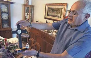  ?? GIOVANNA DELL’ORTO/AP ?? Bob Guerra, a Catholic deacon, holds a crucifix he got to commemorat­e the visit of Pope Francis to the border at his El Paso, Texas, home.