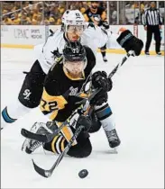  ?? JUSTIN K. ALLER/GETTY ?? The Sharks’ Justin Braun gives the Penguins’ Patric Hornqvist a shot during Thursday night’s Game 5 in Pittsburgh.