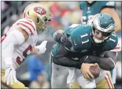  ?? MICHAEL PEREZ — THE ASSOCIATED PRESS, FILE ?? The Eagles’ Carson Wentz (11) is tackled by the 49ers’ Earl Mitchell (90) and Brock Coyle (50) during their 2017game in Philadelph­ia.