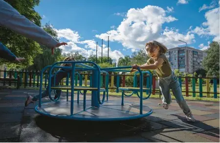  ?? NARIMAN EL-MOFTY/AP ?? Ukrainian children still living in Kramatorsk in embattled eastern Ukraine play on a merry-go-round Thursday as air raid sirens wail.