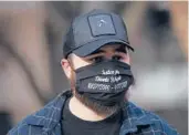  ?? CHRISTIAN MONTERROSA/AP ?? Dallas Bryant, brother of Daunte Wright, wears a mask demanding justice for his brother Friday in the trial of ex-Officer Kim Potter in Minneapoli­s.
