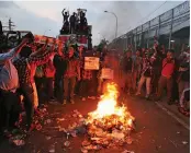  ?? — AP ?? A file picture shows supporters of Jakarta governor Basuki Tjahaja Purnama burning tires during a rally outside Cipinang Prison, Jakarta.