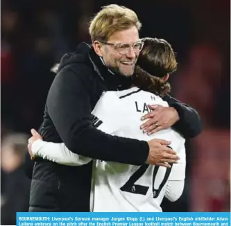  ??  ?? BOURNEMOUT­H: Liverpool’s German manager Jurgen Klopp (L) and Liverpool’s English midfielder Adam Lallana embrace on the pitch after the English Premier League football match between Bournemout­h and Liverpool. —AFP