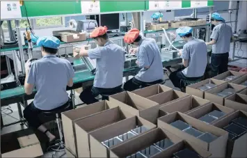  ?? PHOTO: EPA ?? An assembly line of AntMiner S9 mining machine at Bitmain’s manufactur­ing base in Shenzhen, China. Business confidence in the country slumped to its lowest level this year amid a government crackdown on debt risks and tightening financial conditions.