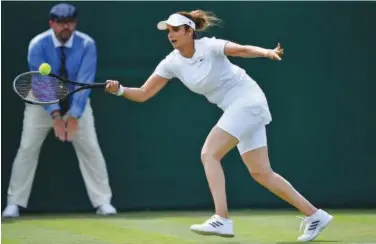  ?? Reuters ?? ↑
India’s Sania Mirza plays a shot during her women’s doubles first round match at the Wimbledon Championsh­ips on Thursday.