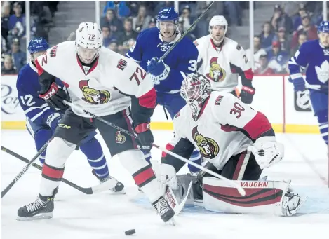  ?? DARREN CALABRESE/THE CANADIAN PRESS ?? Ottawa Senators goalie Andrew Hammond, right, makes a save in front of teammate Thomas Chabot, left, and Toronto Maple Leafs’ Colin Greening, centre, during first period preseason NHL hockey action in Halifax on Monday.