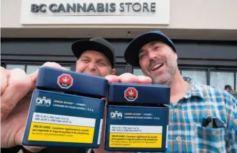  ?? CP PHOTO ?? Don and Aaron (last names withheld) from the United States show off their cannabis purchases outside British Columbia’s first legal cannabis store in Kamloops on Wednesday.