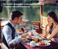  ??  ?? Romantic breakfast onboard traditiona­l Chinese wooden rowboat