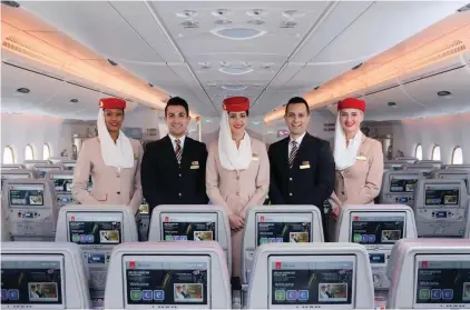  ?? ?? Members of Emirates’ multinatio­nal cabin crew team aboard one of Emirates’ wide-body aircraft