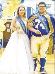  ?? Westside Eagle Observer/MIKE ECKELS ?? Emmy Lee (left) and Javier Perez take their first walk together as queen and king during the 2019 homecoming coronation ceremony at Peterson Gym in Decatur on Friday.