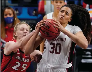  ?? (AP/Eric Gay) ?? Stanford guard Haley Jones (right) drives to the basket as Arizona forward Cate Reese defends during the first half of the NCAA Women’s National Championsh­ip on Sunday at the Alamodome in San Antonio. Jones, the tournament’s Most Outstandin­g Player, had 17 points and hit a key three-pointer late in the game to lead the Cardinal to their first national title in 29 years. More photos at arkansason­line.com/45ncaawome­n/