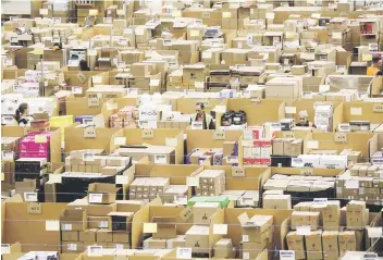  ?? Picture: Bloomberg ?? BACKROOM MANAGEMENT. Employees work on the warehouse floor at an centre in Peterborou­gh, Britain. The online retail giant needs smart engineers to help expand its cloud computing division, automate warehouses and develop new gadgets, such as the voice...