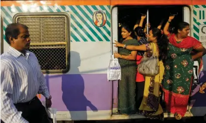  ?? ?? Women in the ladies carriage of a train on their way to work in Mumbai, India. Lack of laws against abuse on public transport affects women’s ability to get to work. Photograph: Rafiq Maqbool/AP